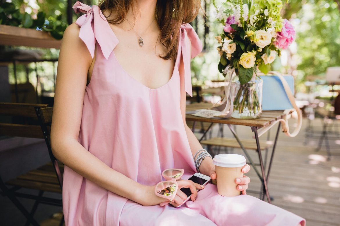 close-up-details-hands-woman-sitting-cafe-summer-fashion-outfit-pink-cotton-dress-sunglasses-drinking-coffee-stylish-accessories-relaxing-trendy-apparel_285396-108